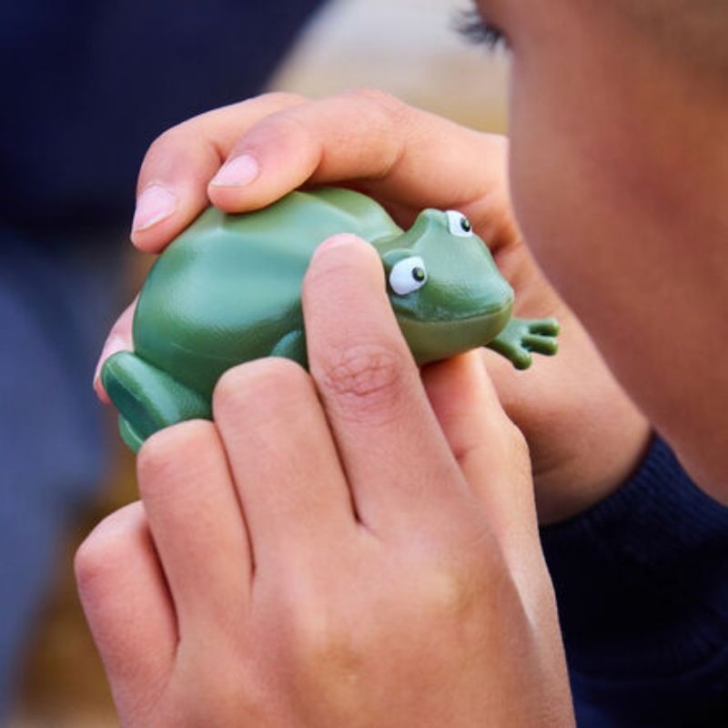 TTS Recordable Talking Frog held in a child's hands, a speech and communication toy for early years classrooms and home use