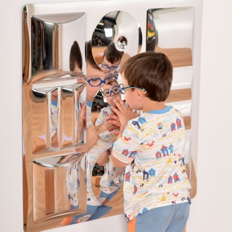 Boy playing with the TTS Sensory Bubble Shapes Mirror, experiencing distorted convex reflections that support visual tracking and self-recognition development