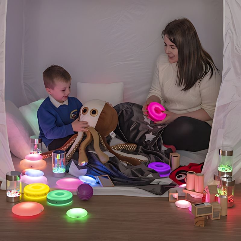 Close-up of a child and parent using the TTS Sensory Retreat Collection sensory calm kit, highlighting the tactile and light-up tools