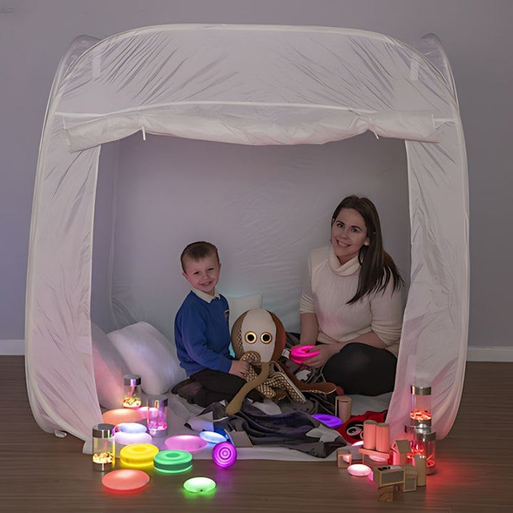TTS Sensory Retreat Collection with child and parent exploring the pop-up sensory tent and tactile glow tools together