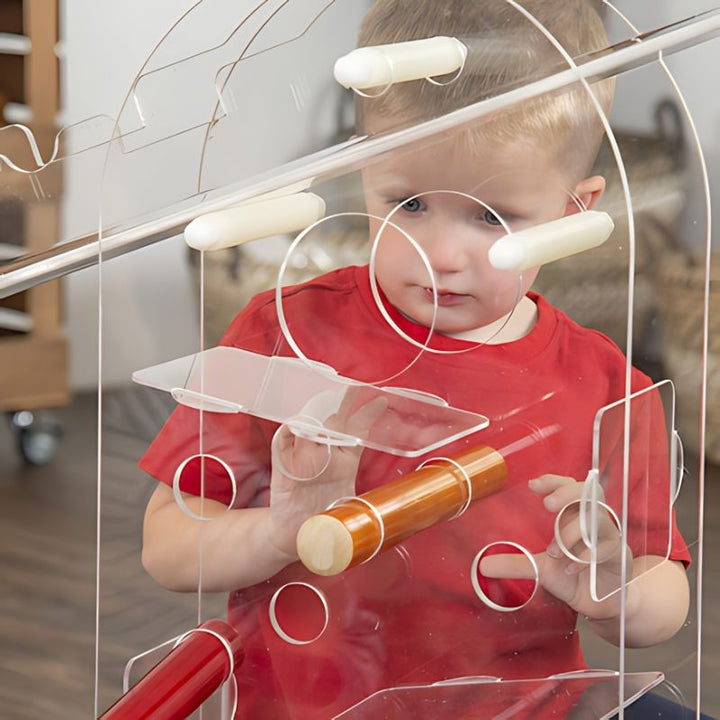 Close-up of a child in a red top interacting with the acrylic components of the TTS STEAM Discovery Centre during sensory play