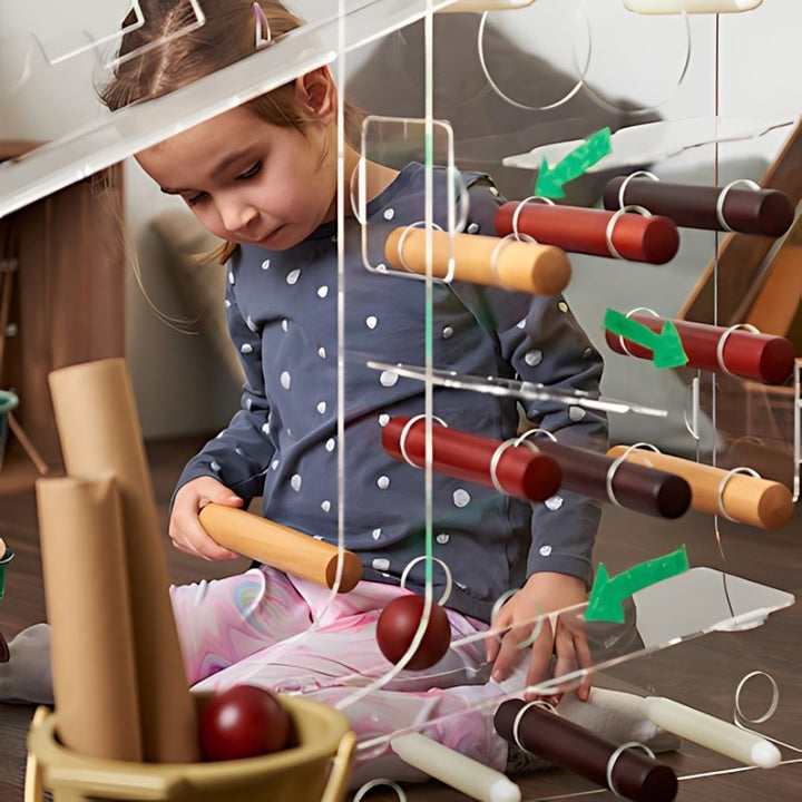 A girl seated at the TTS STEAM Discovery Centre engaging in independent early years STEAM and sensory exploration