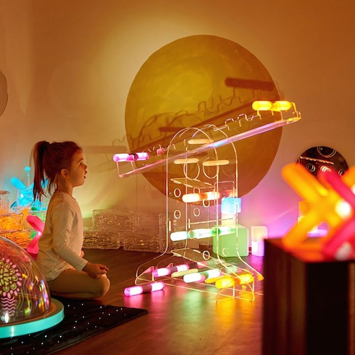 TTS STEAM Discovery Centre showing a seated child actively exploring the acrylic STEAM discovery station with loose parts