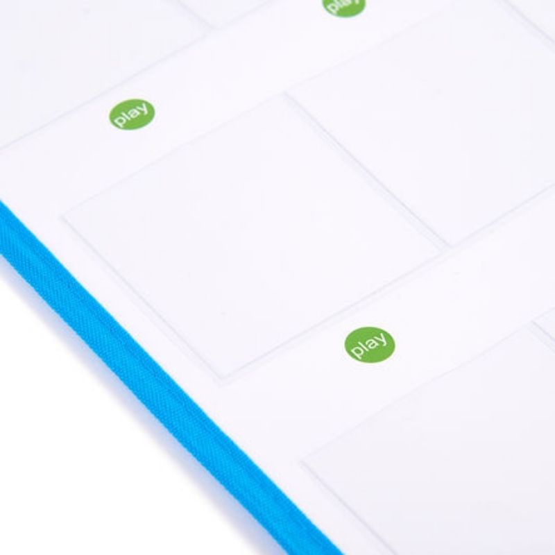 Angled detail of the TTS Interactive Talking Mat showing the clear card pockets with green play buttons and durable blue fabric border used in schools and therapy rooms