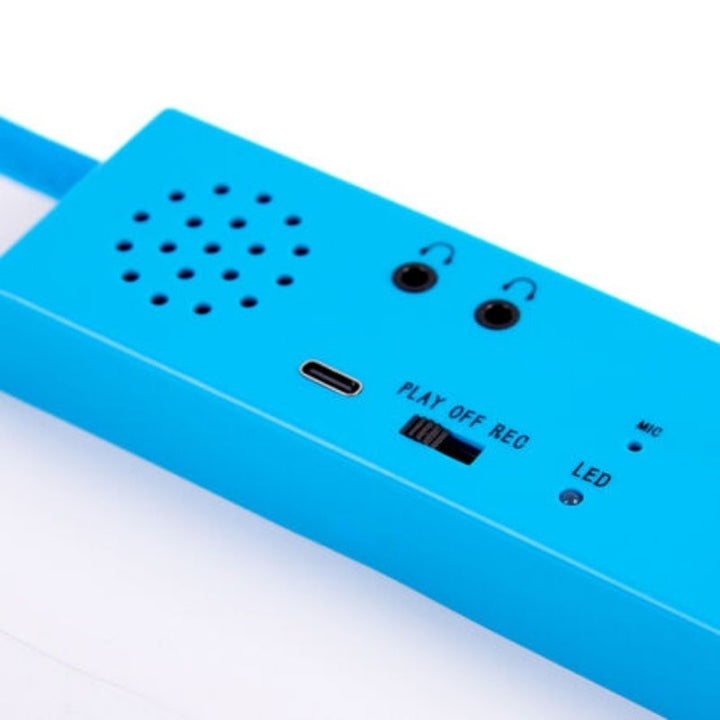 Close-up of the TTS Interactive Talking Mat recording unit showing dual headphone sockets, USB-C charging port, speaker, and the PLAY/OFF/REC switch