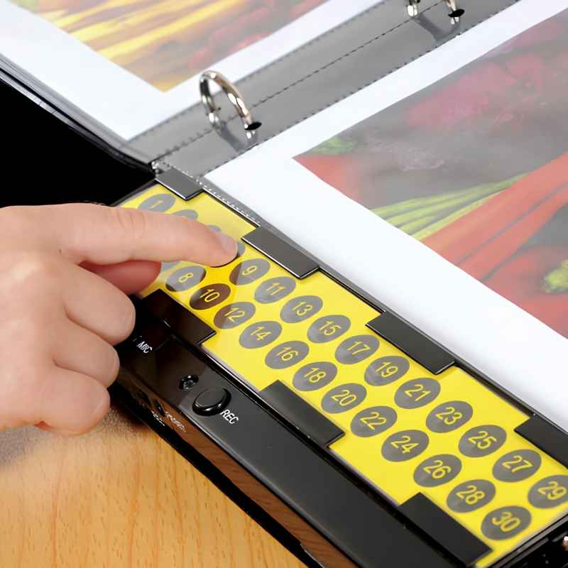 Close-up of a child pressing a numbered recordable button on the TTS A4 Talking Photo Album, showing the 30-button yellow panel with REC switch and built-in microphone used for classroom communication and auditory learning