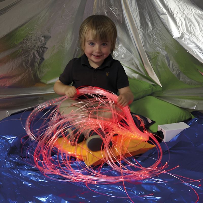 TTS Rechargeable Wireless Sensory Fibre Optic Strands held by a child during active sensory play, showing the colour-changing LED light effect