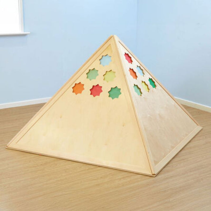 Exterior of the TTS Learning Location Wooden Pyramid Den with its star-shaped cut-outs filled with coloured inserts, showing how the den can be customised