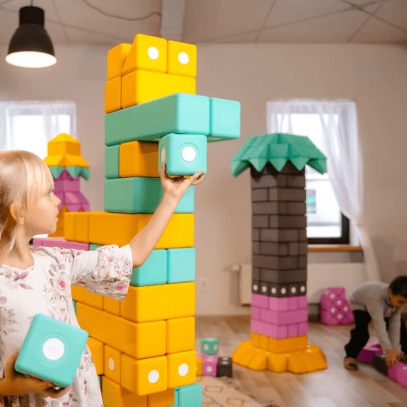 Two children building together in a landscape view with TUKI Big Magnetic Foam Blocks Smart 280, supporting collaborative sensory building and social skill development