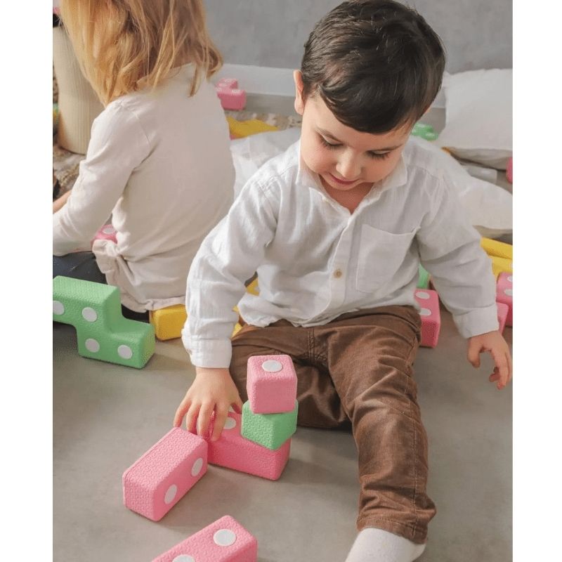 Two children playing collaboratively with the TUKI Regular Magnetic Blocks 48 Elements group set, demonstrating the social communication and joint construction the 48-element award-winning foam block set supports
