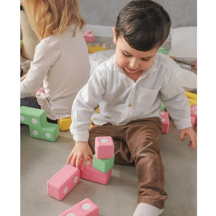 Two children playing collaboratively with the TUKI Regular Magnetic Blocks 48 Elements group set, demonstrating the social communication and joint construction the 48-element award-winning foam block set supports