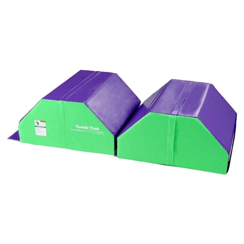 Side view of the Tumbl Trak Octagonal Tumbler in green and purple showing the height profile and curved surface that provides the elevated arc for back handspring, walkover, and leap progression training