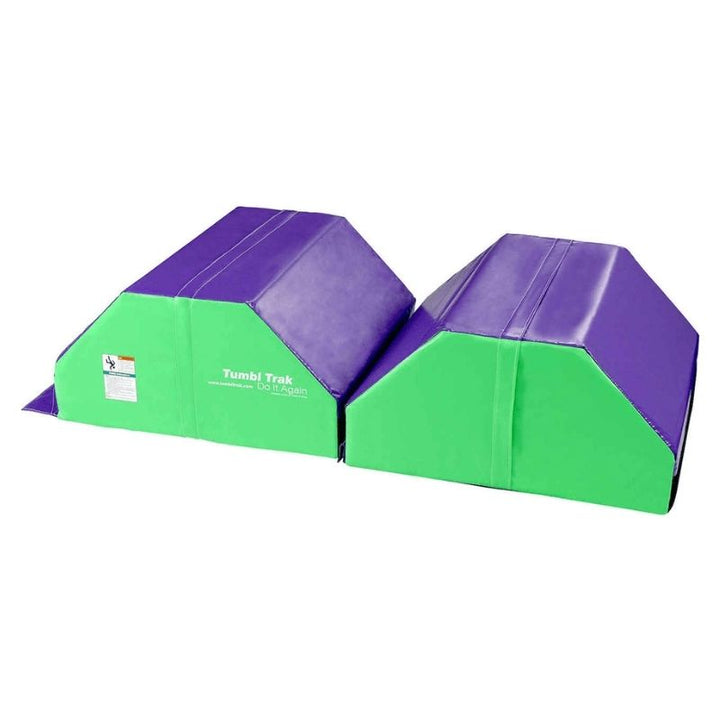 Side view of the Tumbl Trak Octagonal Tumbler in green and purple showing the height profile and curved surface that provides the elevated arc for back handspring, walkover, and leap progression training