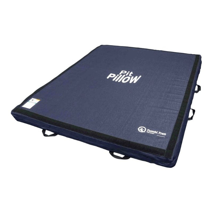 Tumbl Trak Pit Pillow third landscape view showing the low-density foam gymnastics mat with removable denim cover, vacuum-packed for shipping and requiring 48 hours to fully expand before first use