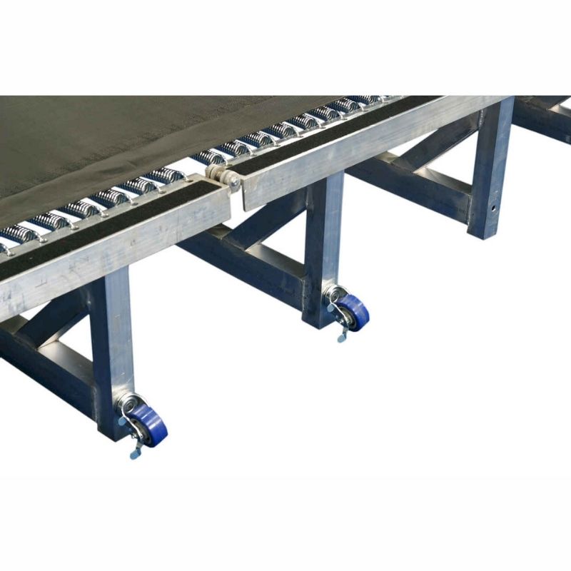 Close-up view of the Tumbl Trak Porta Trak showing the aluminium frame detail, polypropylene bed surface, 4-inch springs, and folding hinge construction that makes this portable gymnastics tumbling track half the weight of the Original Tumbl Trak