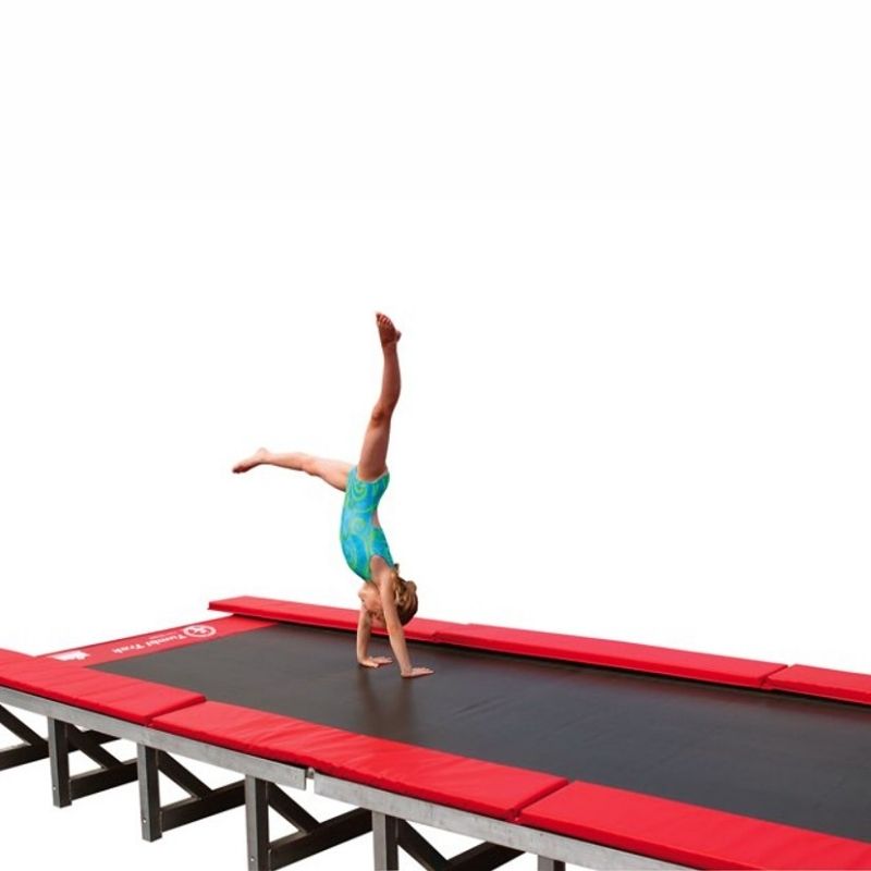 Young girl performing a gymnastics skill or handstand on the Tumbl Trak Porta Trak, demonstrating the spring-bed polypropylene tumbling surface that delivers the same performance as the Original Tumbl Trak in a foldable aluminium frame