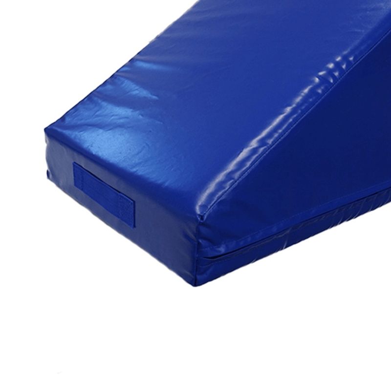 Corner view of the Tumbl Trak Smart Wedge showing the heavy-grade vinyl cover, dense foam construction, and the geometric profile of the three-angle gymnastics training block for skill progression work at bars, beam, and floor