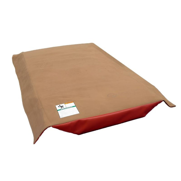 Tumbl Trak T-Trainer Cover PRO top view showing the full tan suede vault surface, red padded trim, and safety label - a gymnastics vault trainer topper for gyms across North America
