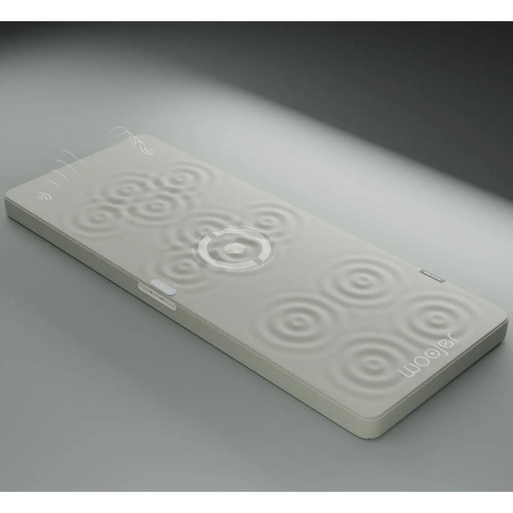Woojer MAT Pro vibroacoustic mat with ripple graphics showing its haptic zones, a haptic wellness mat that turns sound into full-body vibration
