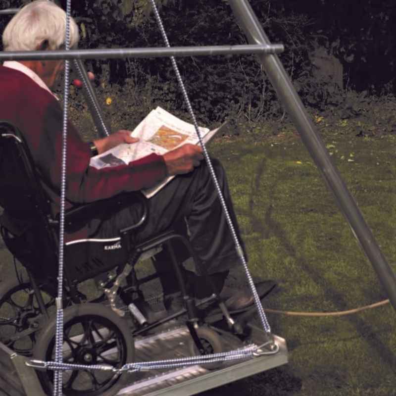 Close view of the securing straps and adjustable ropes on the TFH Wheelchair Platform Swing with Frame holding a wheelchair in place