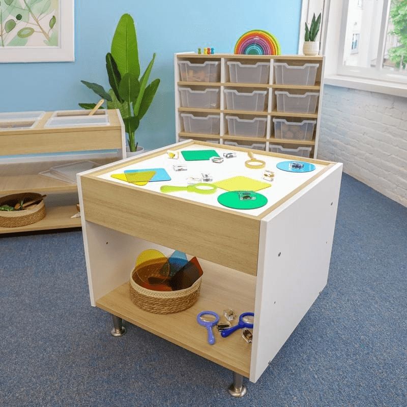 Whitney Brothers elevatED Adjustable Light Table in a classroom setting, showing the full 26" wide table with two-tone white oak and white panel design in an indoor Early Learning environment