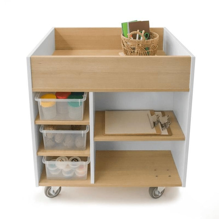 Whitney Brothers elevatED Art Supply Cart with art supplies organised in the front compartments, back paper slots, and top liquid storage well of the mobile classroom art storage cart