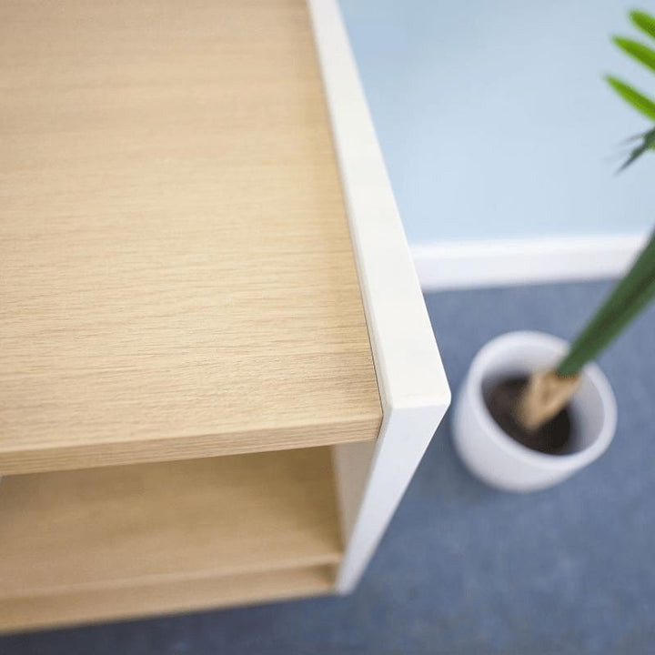 Close-up corner view of the Whitney Brothers elevatED Combo Tray Storage Cabinet showing the professional-grade edge banding, 3/4-inch thermofused melamine construction, and brushed nickel leg detail