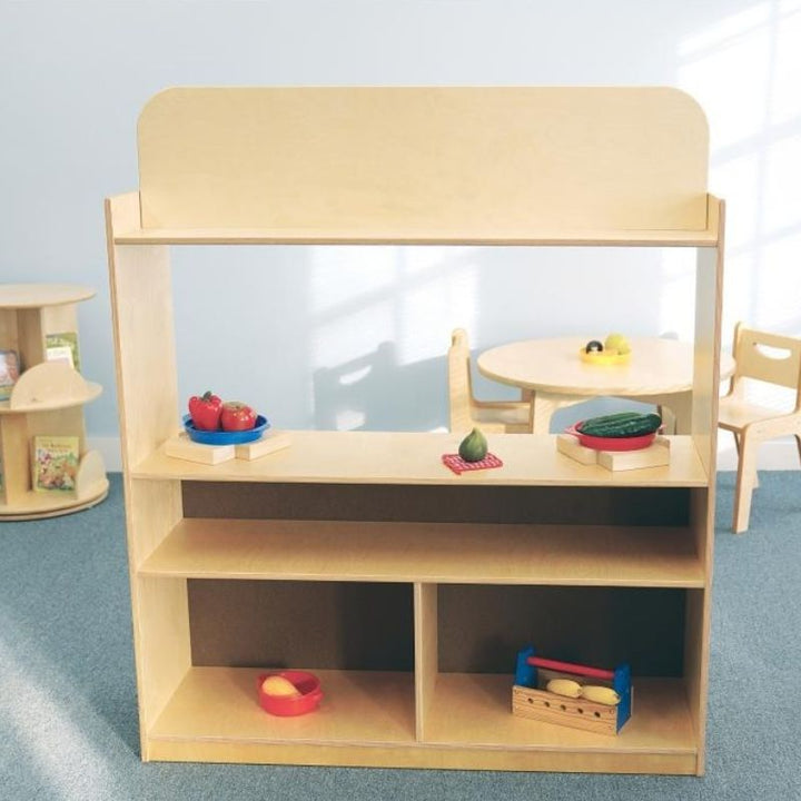 Rear view of the Whitney Brothers Imagination Station showing the two fixed back shelves with three storage compartments for dramatic play props and puppets