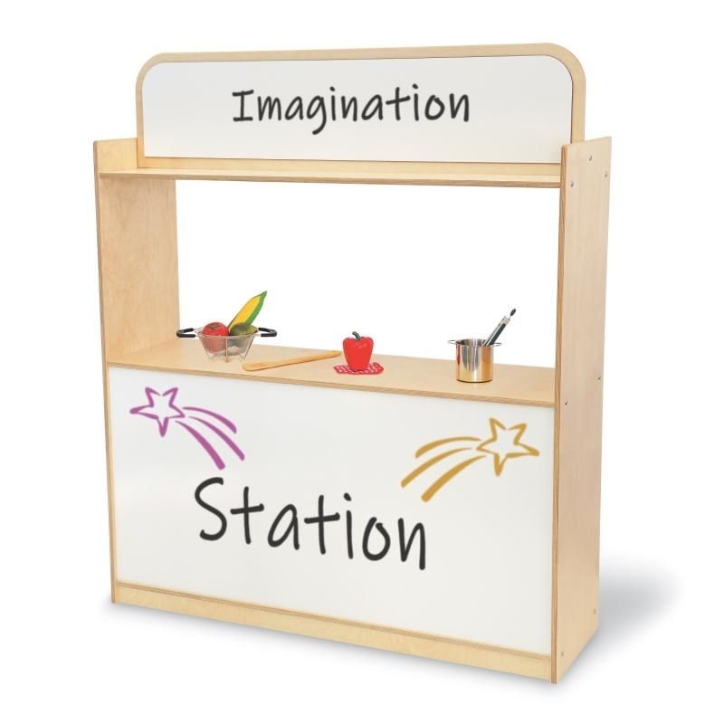 Front view of the Whitney Brothers Imagination Station with sample dry erase signage, showing the stage opening, upper and lower dry erase boards, and 48.75" wide dramatic play unit