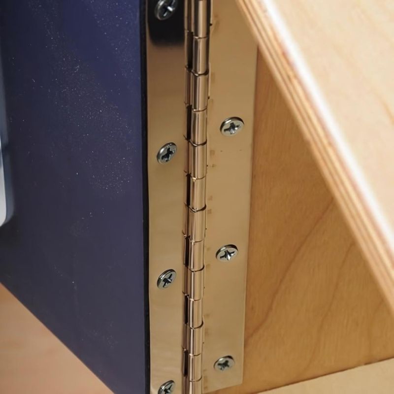 Whitney Brothers Monaco Combo Kitchen safety hinges shown across cabinet doors, demonstrating the child-safe continuous hinge construction of this birch plywood play kitchen