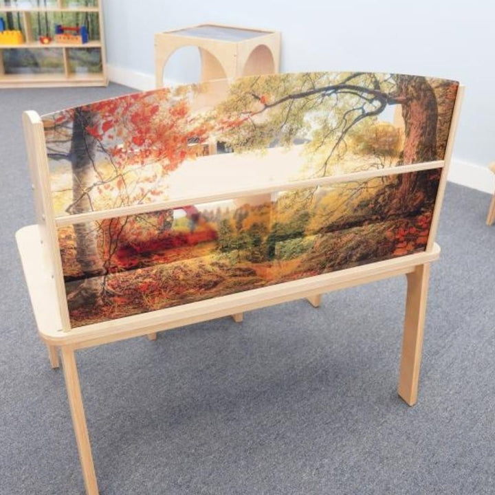 Rear view of the Whitney Brothers Nature View Writing Center showing the clear shatterproof acrylic forest scene panel from behind, demonstrating the unobstructed adult supervision visibility