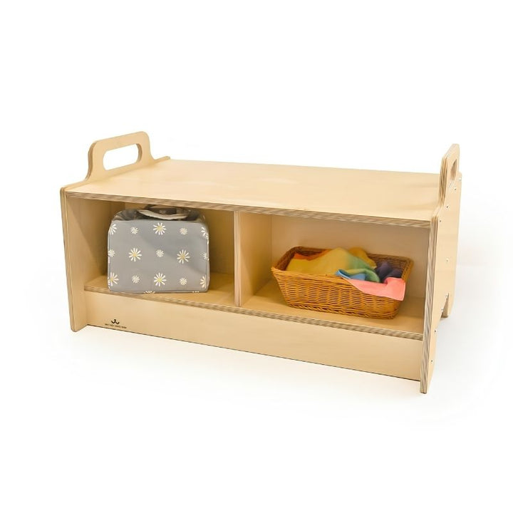 Whitney Brothers Stack-Able Bench with classroom materials stored in the two divided compartments, including a fabric bag and wicker basket with sensory scarves