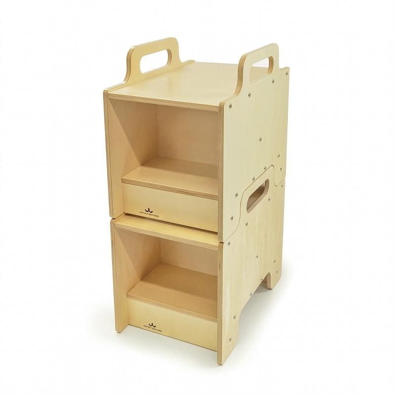 Two Whitney Brothers Stack-Able Seats interlocked and stacked to create a two-tier open storage cabinet, demonstrating the flexible classroom furniture design that converts seating into storage