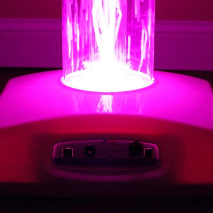 Base of the TFH Wireless Hurricane Tube glowing pink, showing the controller ports on this wireless sensory light