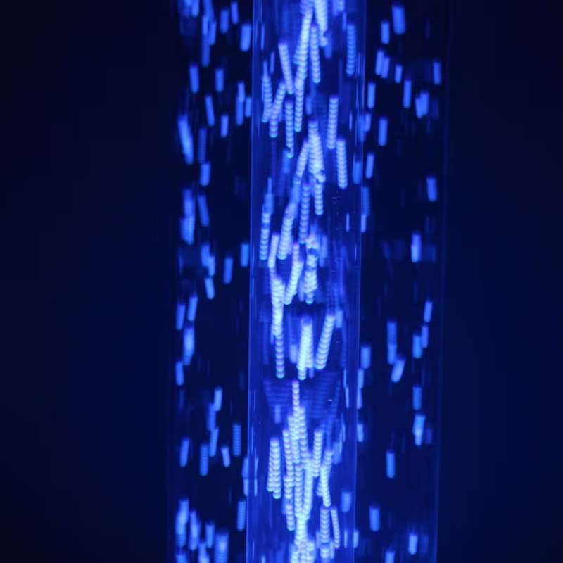 Close up of light beads swirling inside the TFH Wireless Hurricane Tube, a waterless sensory light shown in calming blue