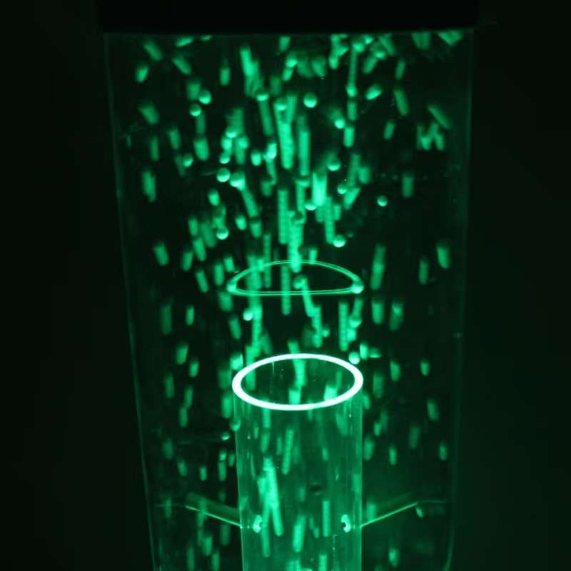 Top section of the TFH Wireless Hurricane Tube in green light, showing the acrylic column and rising sensory beads