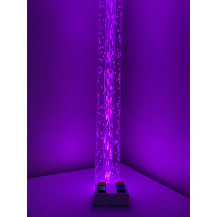 Full length view of the TFH Wireless Hurricane Tube glowing purple on the floor, a wireless sensory light for therapy rooms