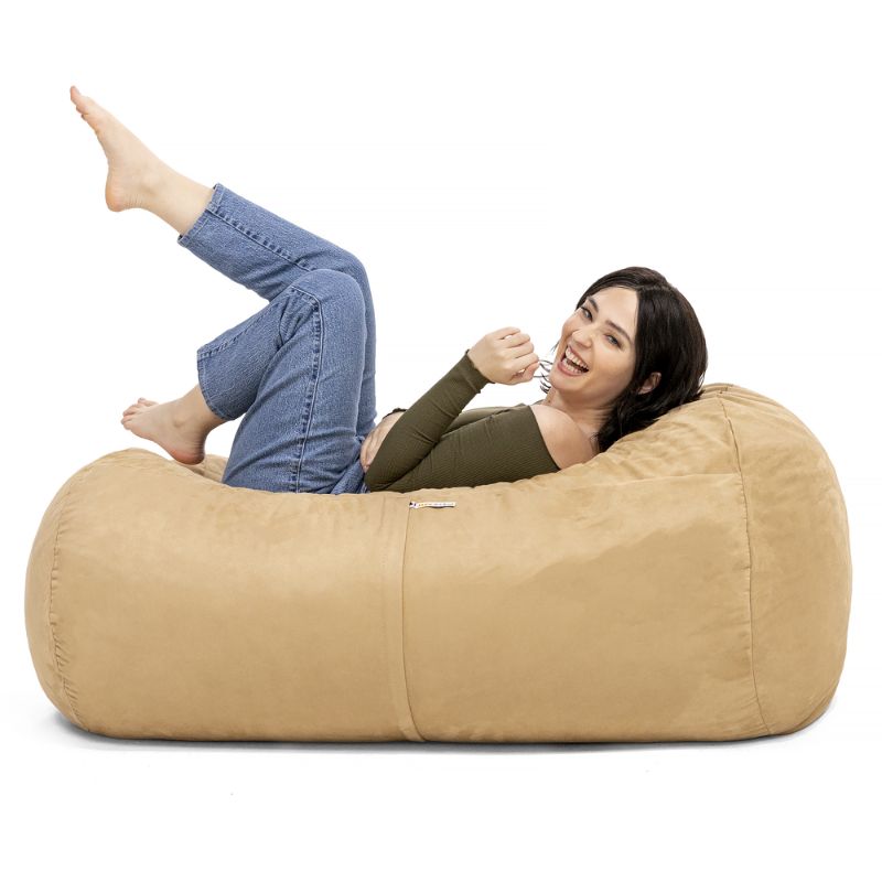 Woman relaxing on the Jaxx Lounger 4ft bean bag chair in Tan microsuede, a washable deep pressure seat