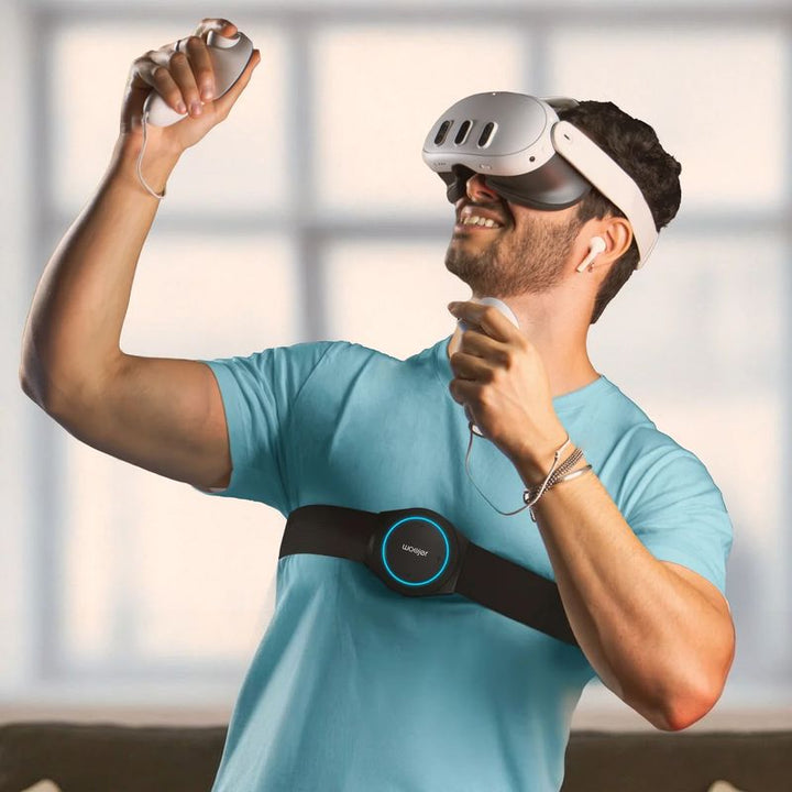 Person playing VR while wearing the Woojer Strap 4 across the chest, a wearable haptic device that adds body-felt sound to virtual reality
